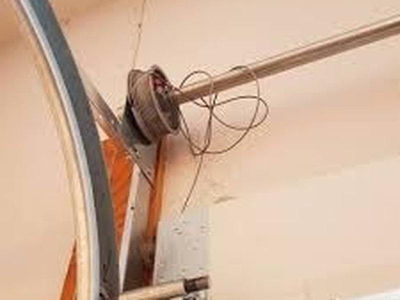 Cable and pulley at the upper corner of a garage door track